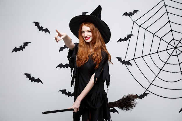 Premium Photo | Happy elegant witch enjoy playing with broomstick.