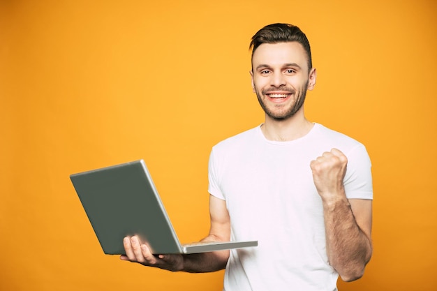 Premium Photo | Happy and excited man in white t shirt with laptop in ...