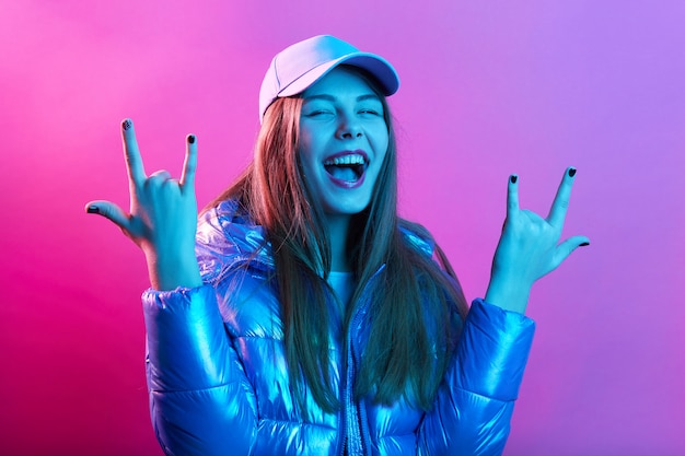 Happy excited woman showing rock gesture with fingers Free Photo