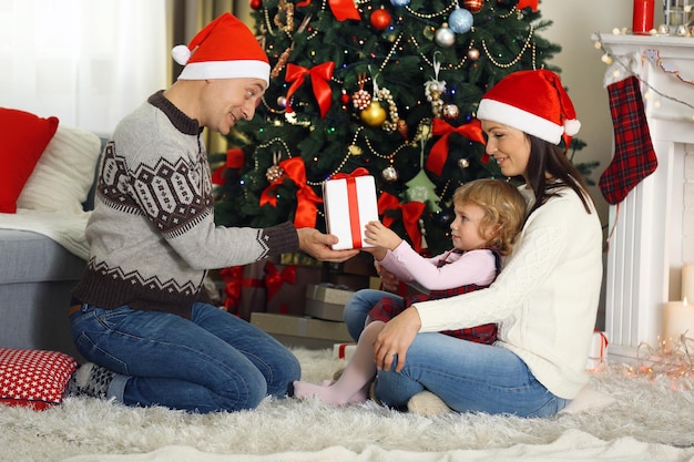 Premium Photo | Happy family on christmas tree background