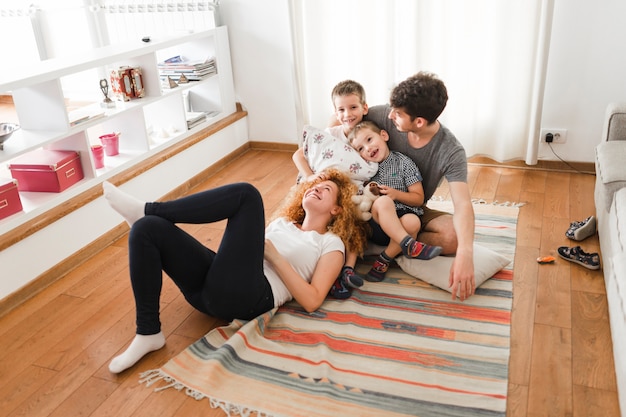 Happy family hanging out in living room Free Photo