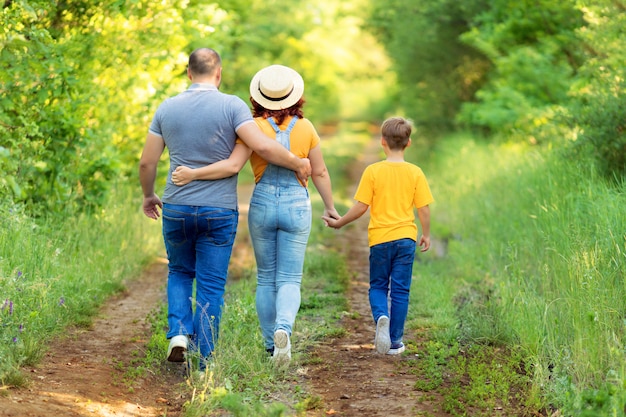 Premium Photo | Happy family, mom, dad, son walk, holding hands ...