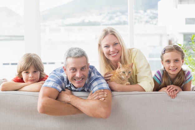 Happy Family With Cat On Sofa At Home Premium Photo