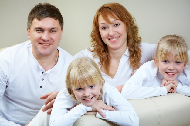 Happy family with twins on the couch Photo | Free Download