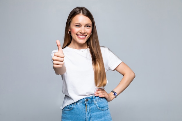 Happy female college student showing thumbs up isolated Free Photo
