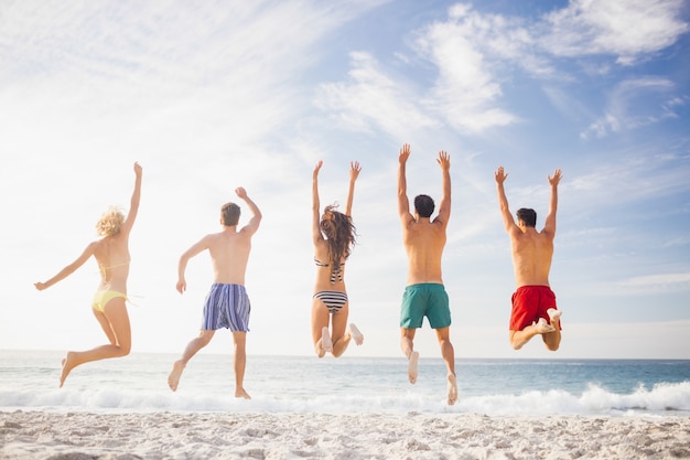 Premium Photo | Happy friends jumping together