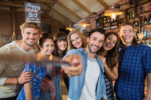 Premium Photo Happy Friends Taking Selfie In Pub