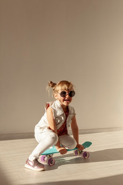 Free Photo | Happy girl sitting on skateboard