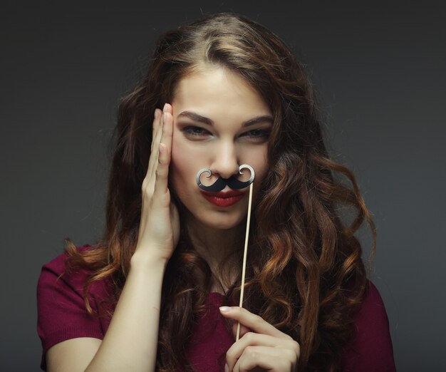 Premium Photo | Happy girl wearing fake mustaches