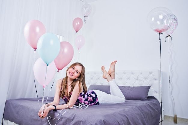 Premium Photo Happy Girl With Colored Balloons On Bed At Room Celebrating Birthday Theme