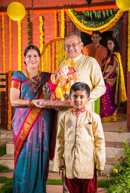 Premium Photo | Happy indian family celebrating ganesh festival or ...