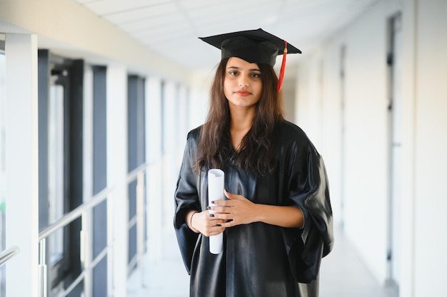 Premium Photo | Happy indian university student in graduation gown and