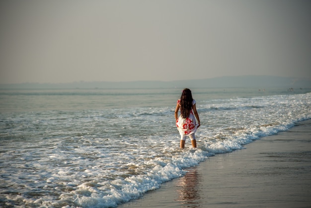 Premium Photo | Happy indian woman enjoying a vacation on the beach.