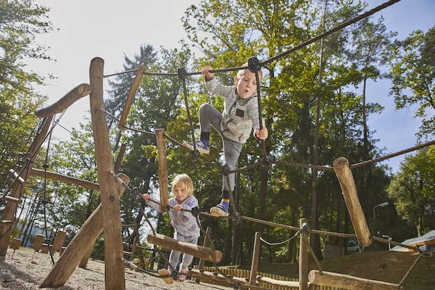 Happy kids playing in the wooden playground during the daytime Free Photo