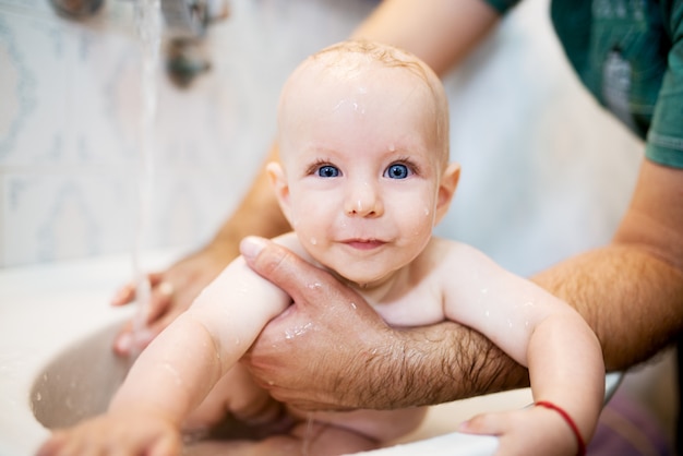 Happy laughing baby taking a bath. little child in a ...