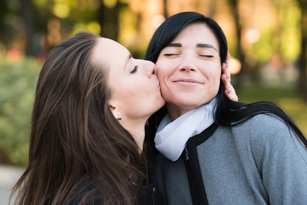 Premium Photo Happy Lesbian Caucasian Couple Kissing On The Cheek