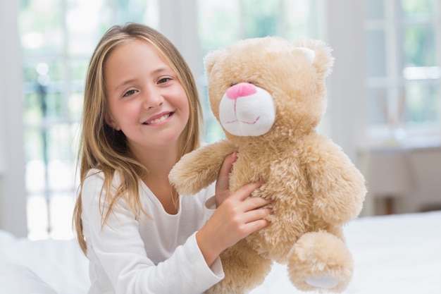 girl holding teddy