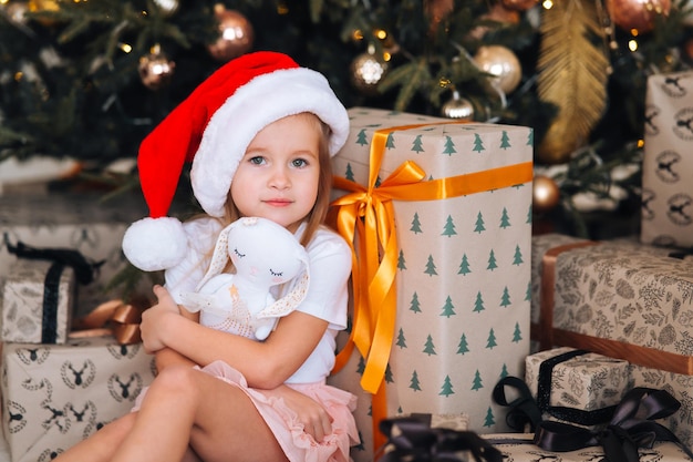 Free Photo | Happy little girl hugs her favorite toy in the room