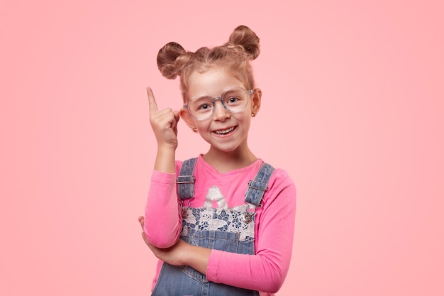 Premium Photo | Happy little smart girl in denim overall and spectacles ...