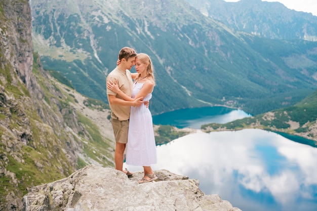 https://image.freepik.com/free-photo/happy-loving-couple-standing-together-high-in-the-mountains-with-beautiful-lake-behind_149066-4097.jpg