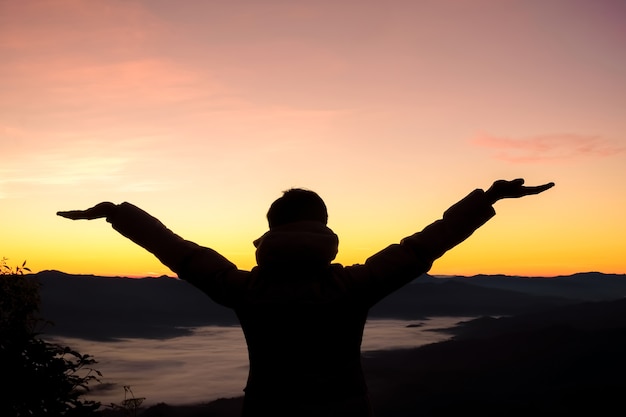 Premium Photo | Happy man at sunset or sunrise standing elated with ...