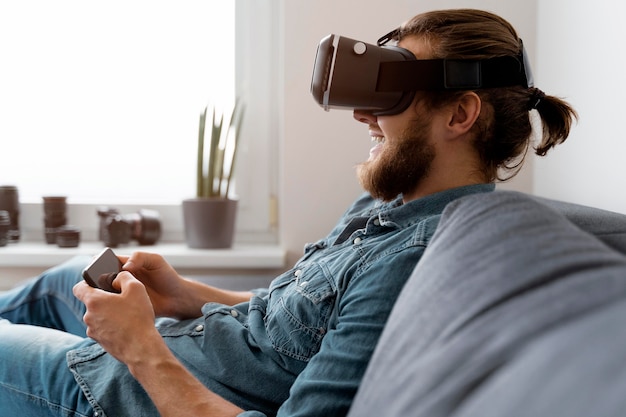 Free Photo | Happy man with vr glasses holding phone