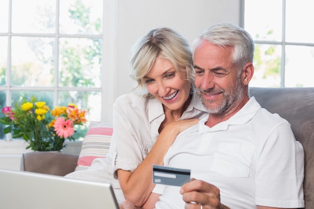 Premium Photo Happy Mature Couple Doing Online Shopping At Home