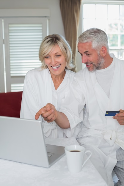 Premium Photo Happy Mature Couple Doing Online Shopping At Home