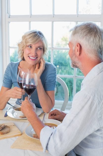 Premium Photo | Happy mature couple toasting drinks over food