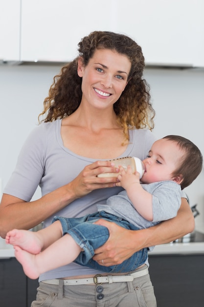 Premium Photo | Happy mother feeding milk to baby