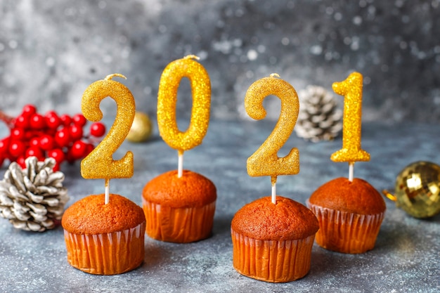 Free Photo | Happy new year 2021,cupcakes with golden candles.