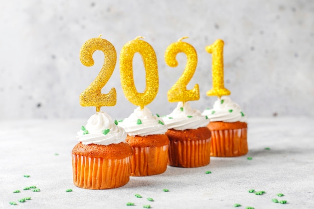 Free Photo | Happy new year 2021,cupcakes with golden candles.
