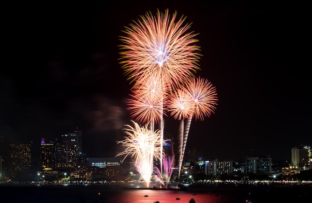 Happy new year fireworks over cityscape at night. holiday celebration festival Premium Photo