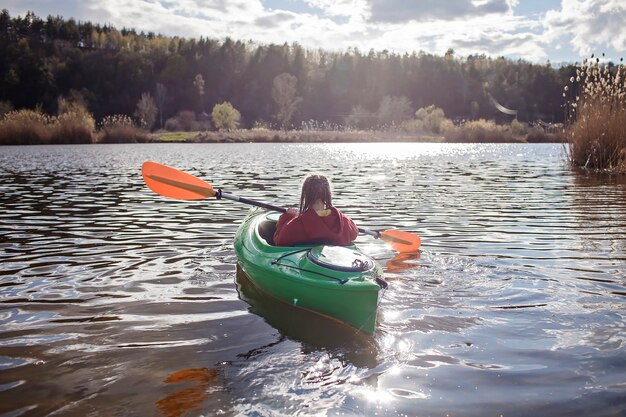 Premium Photo | Happy preteen girl kayaking on river paddle in the hand ...