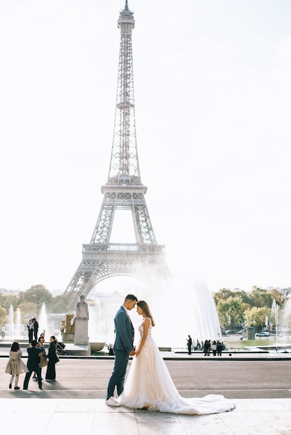 Premium Photo | Happy romantic married couple hugging near the eiffel ...