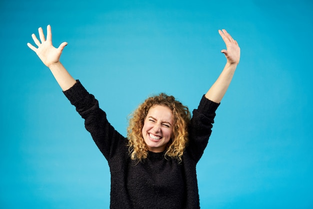 Happy satisfied young redhead curly woman celebrating and cheering ...