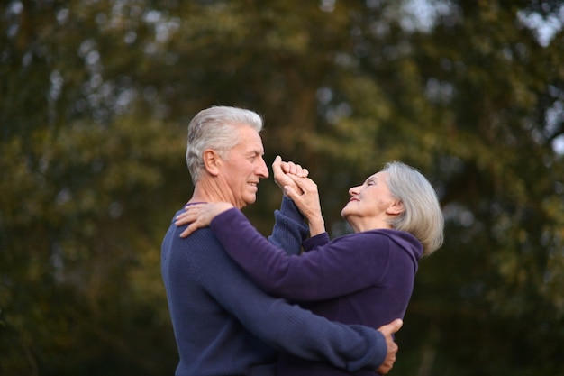 Premium Photo Happy Senior Couple Dancing In Summer Park