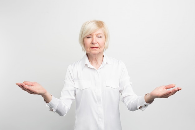 Premium Photo | Happy senior lady meditating. she is searching for calm ...