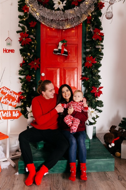 Download Free Photo Happy Smiling Family At Studio On Background Of The Christmas Tree With Gift PSD Mockup Templates