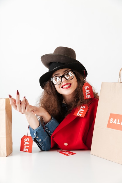 Free Photo | Happy smiling sale woman sitting with paper shopping bags