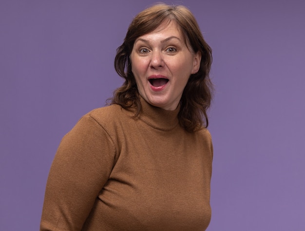 Free Photo | Happy and surprised middle aged woman in brown turtleneck ...