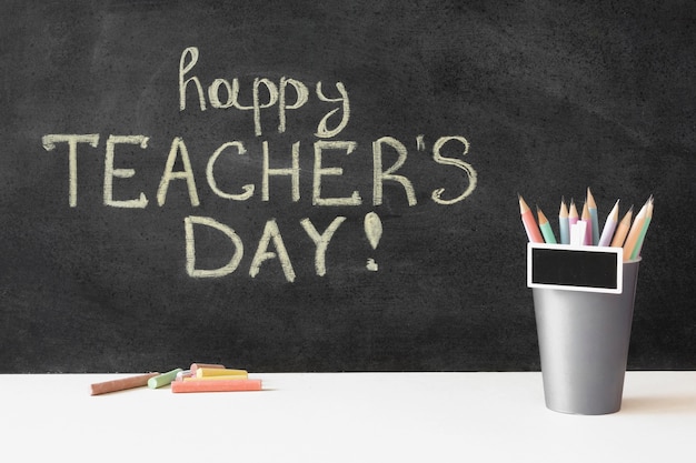 Premium Photo | Happy teacher's day on blackboard and pencils