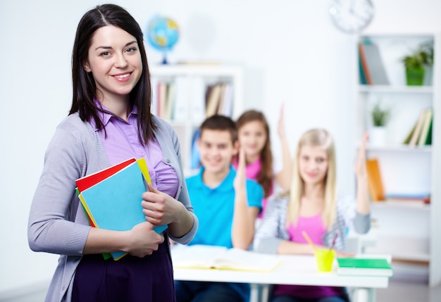 Happy teacher with students background Free Photo