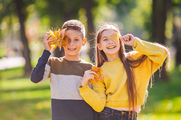 Premium Photo Happy Twins Teenagers Boy And Girl Posing Hugging Each Other In Autumn Park