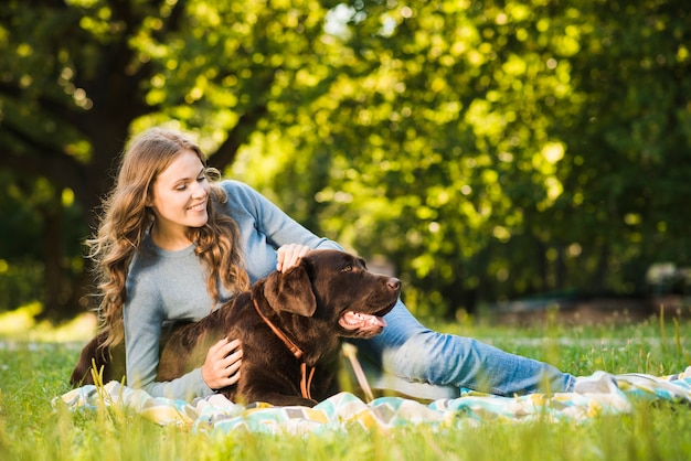 Free Photo | Happy woman having fun with her dog in garden