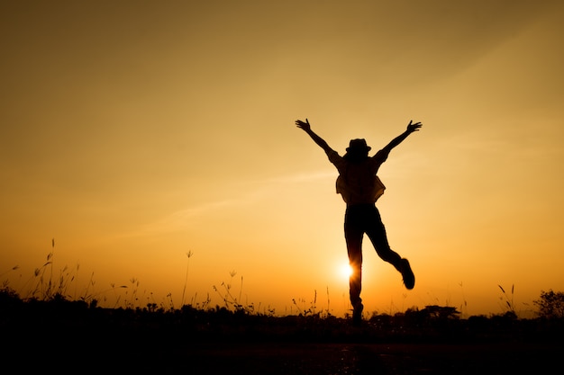 Premium Photo | Happy woman jump and sunset silhouette