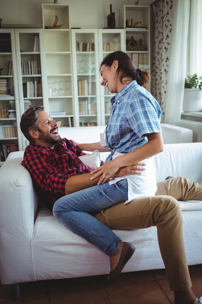 Happy Woman Sitting On Mans Lap In Living Room Premium Photo