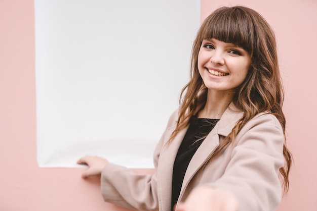 Premium Photo The Happy Woman Standing On The Pink Wall Background 