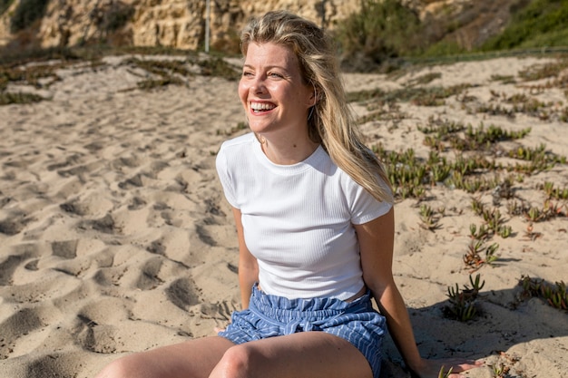 Free Photo | Happy woman in white top beach photoshoot