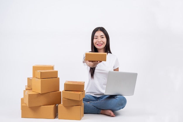 Happy women from ordering products from customers, business owners who work at home on a white backg Free Photo